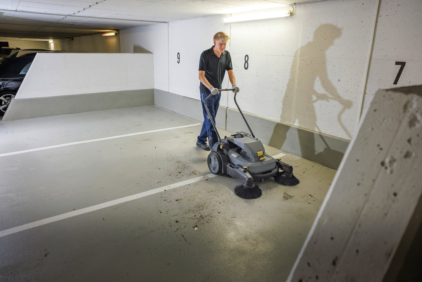 Karcher Sweeper KM 70/30 C BP PACK 2SB *KNA Commercial Walk-Behind Vacuum Sweeper parkade sweeping in use