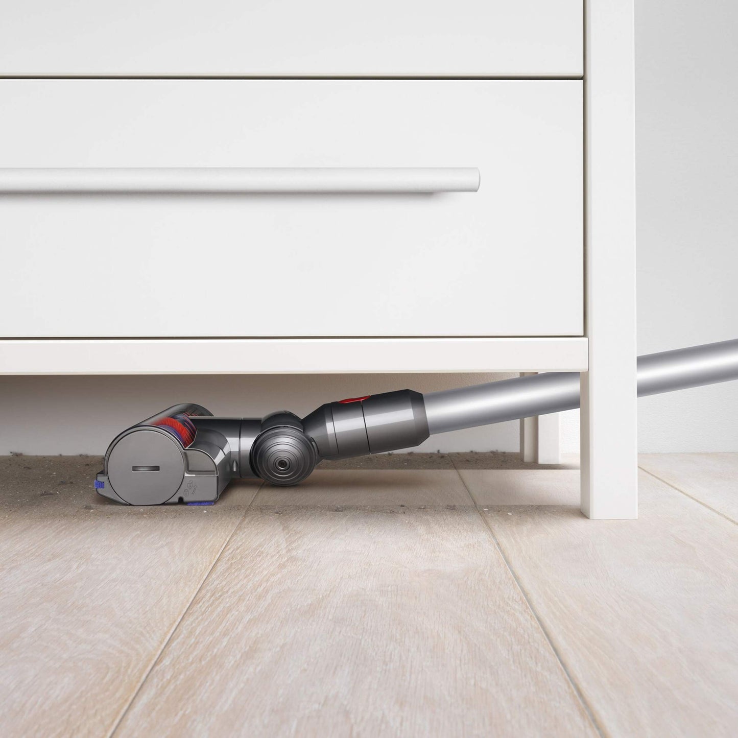 Dyson V7 Advanced vacuuming dirt under dresser