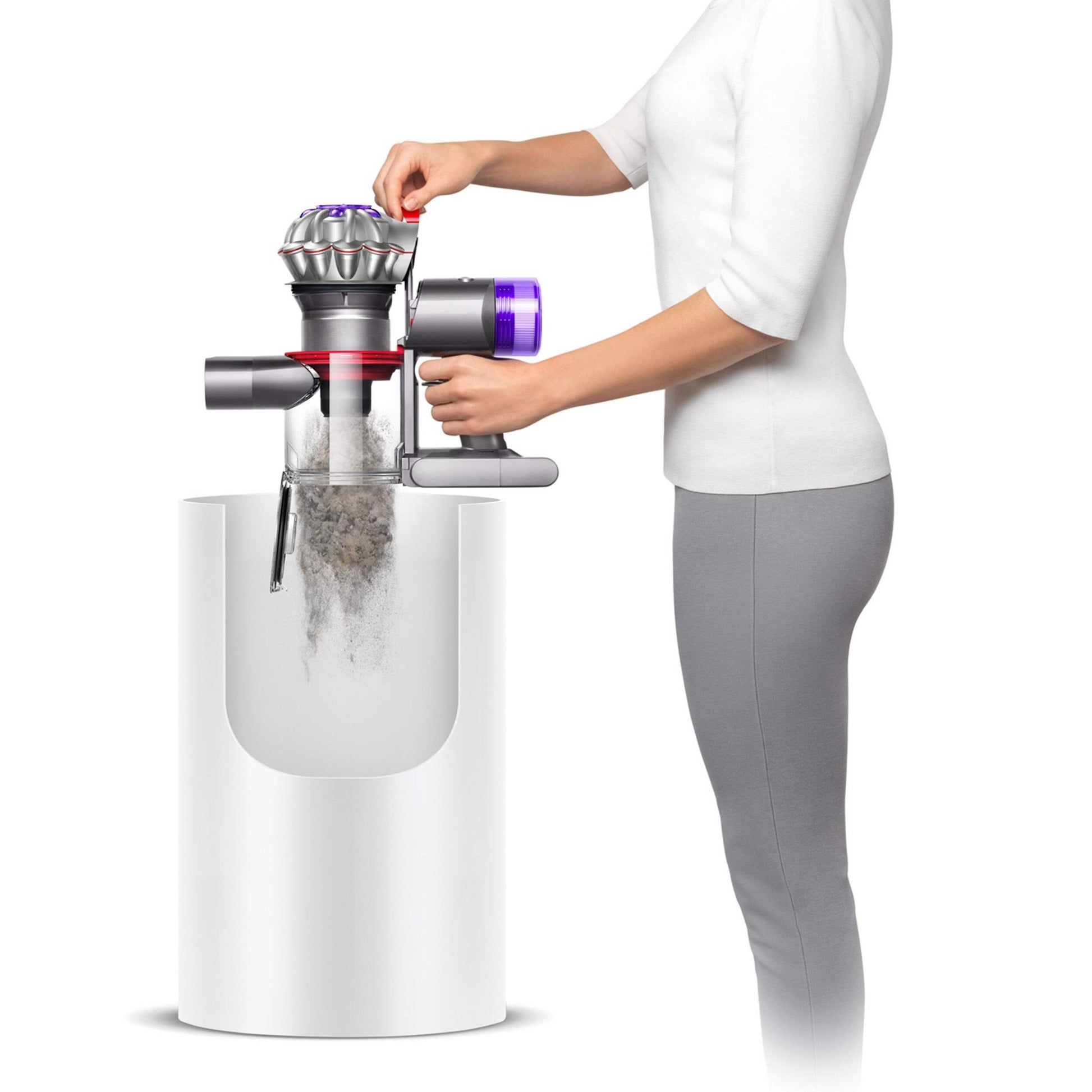Girl emptying dirt into garbage Dyson V7 Advanced Cordless Stick vacuum