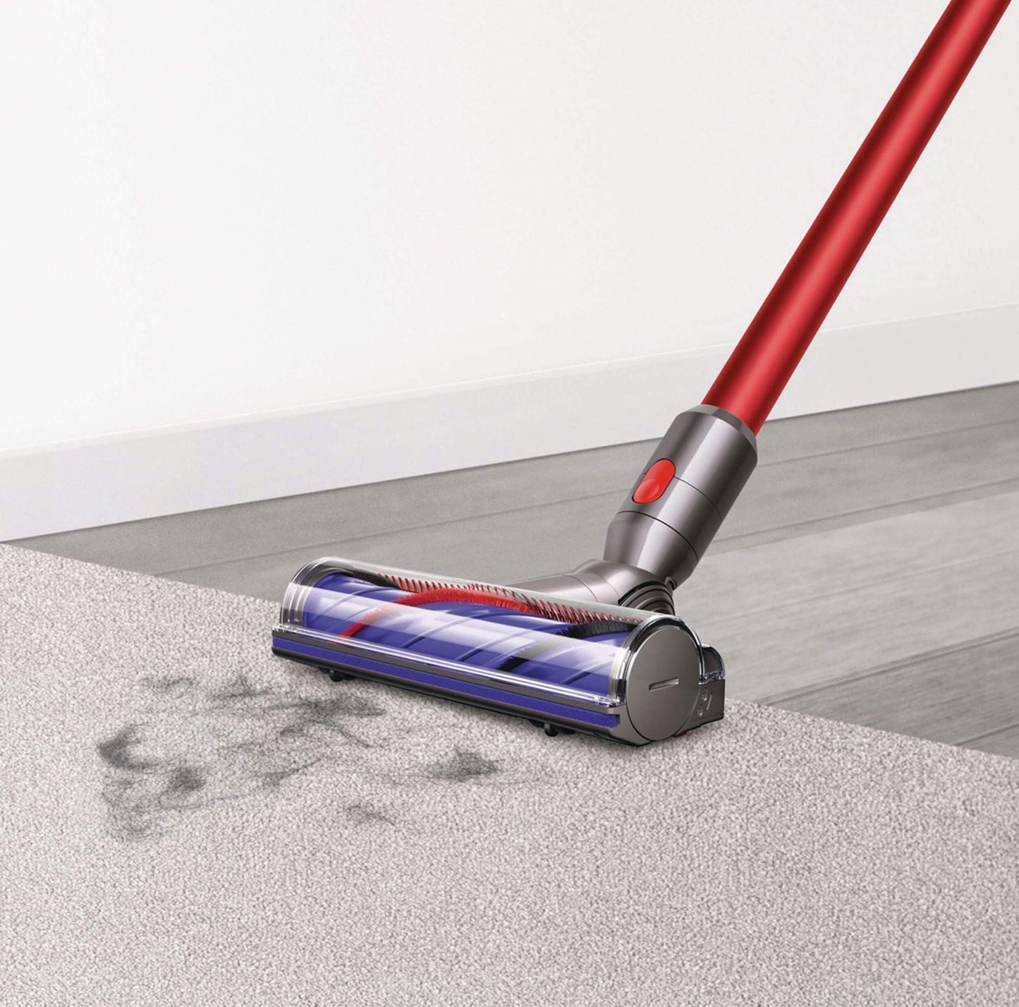Dyson V8 Origin Cordless Stick vacuum vacuuming hair off carpet