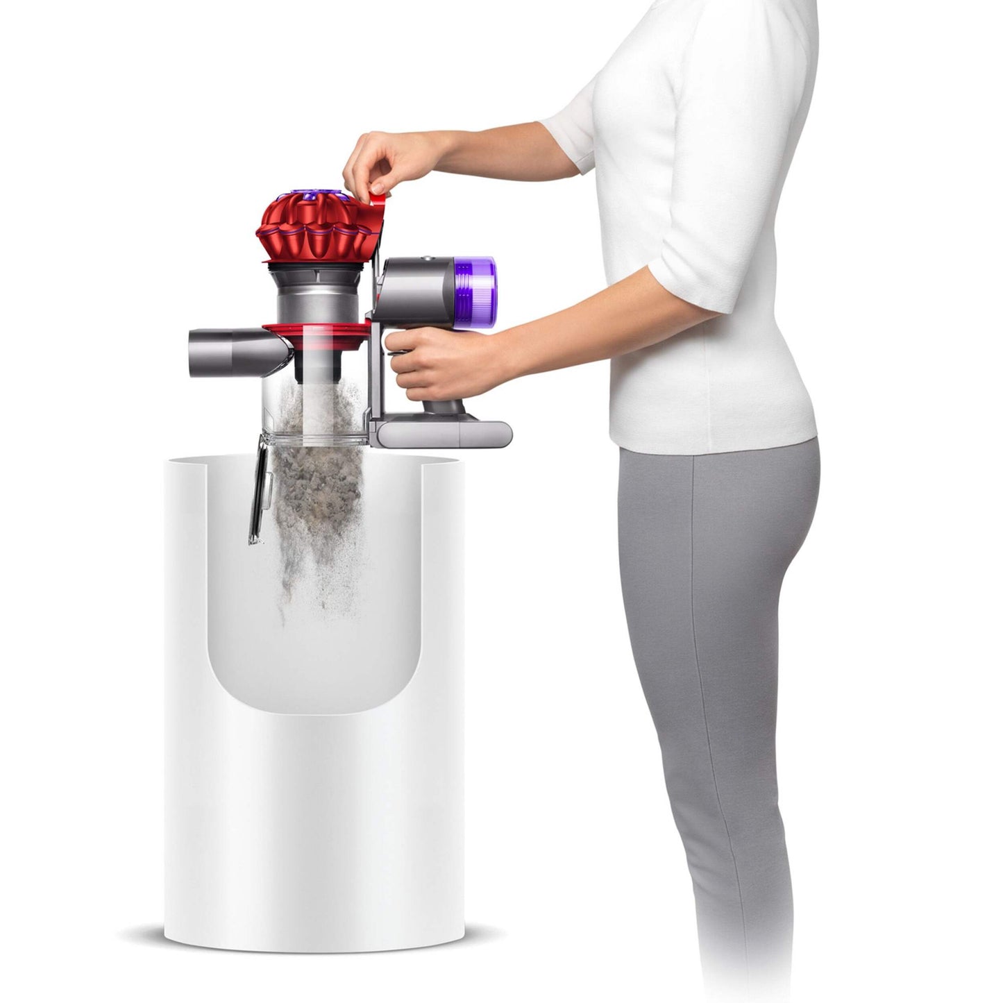 Girl Empyting dirt bin over garbage Dyson V8 Origin