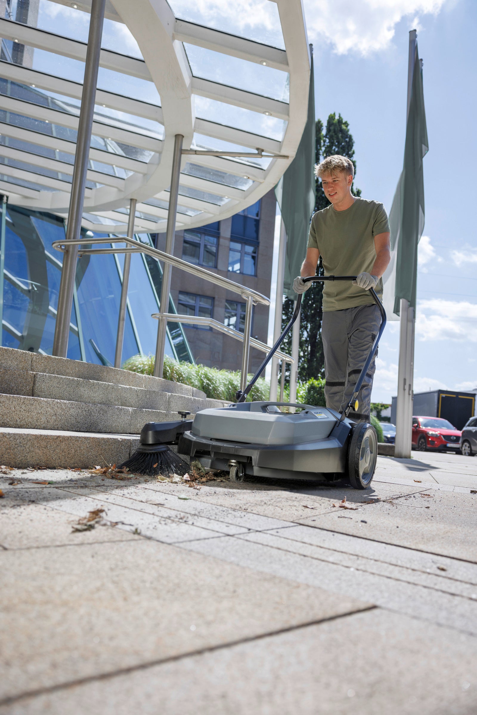 Karcher KM 70/20 C Manual Sweeper sweeping out door and leaves