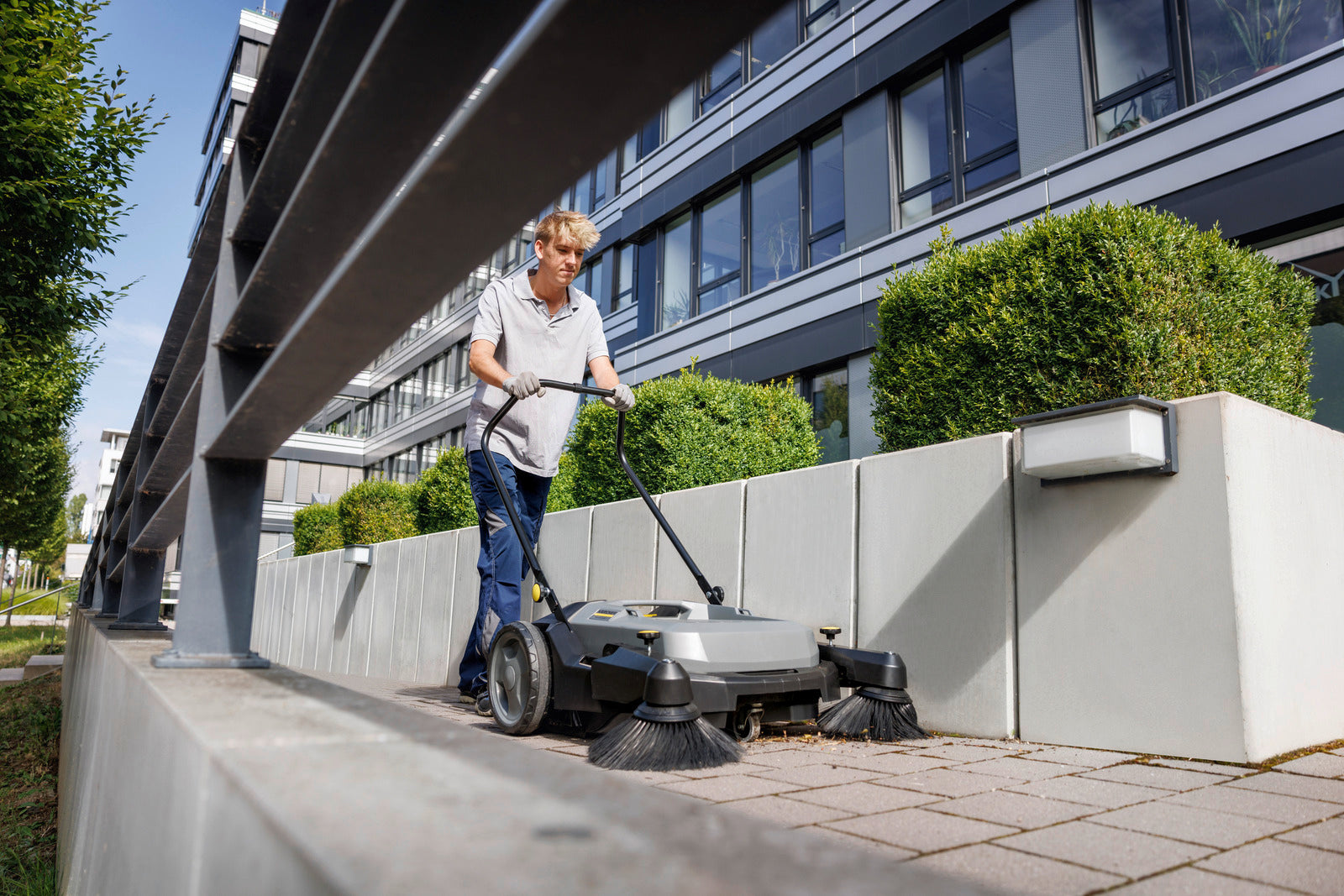 Karcher KM 70/20 C 2SB Manual Walk-Behind Compact Floor Sweeper W/ Dual Brushes sweeping leaves