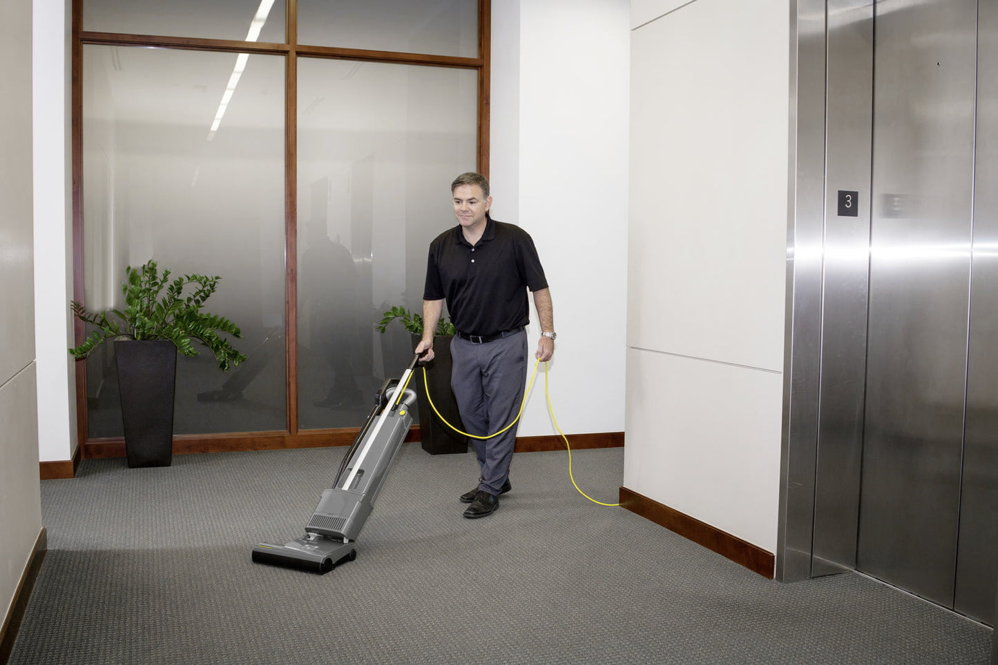 Karcher Versamatic® HEPA 14 Upright Vacuum Cleaner in use vacuuming hall ways 