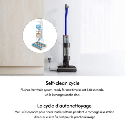 Dyson washG1 Charging in docking station on wall. displaying diagram of how the water and dirt are filtered in the vacuum. English and French text overlay explaining the self cleaning cycle