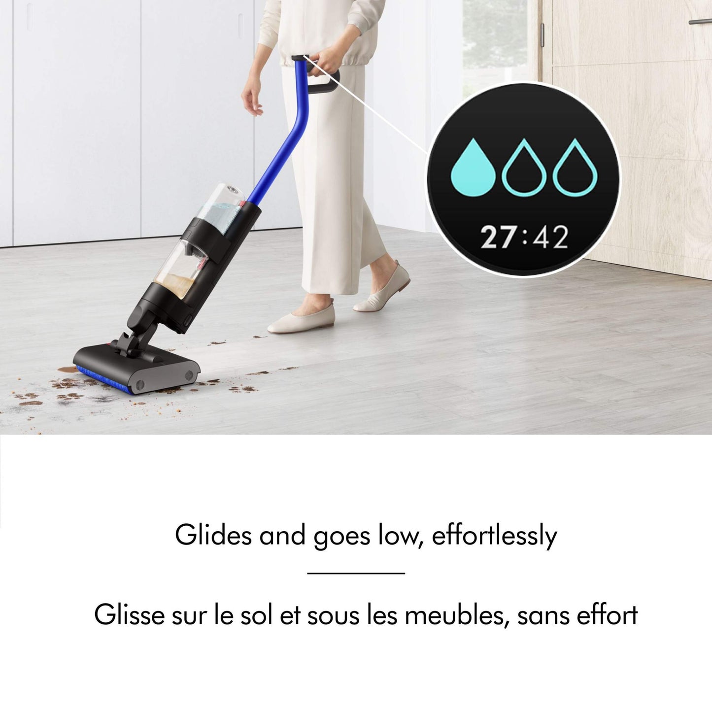 Girl using Dyson washG1 vacuum to clean dirt and liquid, with run-time display and English and French text overlay explaining the process.