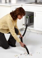 lady using Vroom Cabinet retractable Hose system