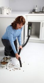 Lady Using Vroom Cabinet retractable Hose system