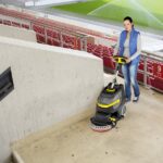 woman using Karcher BD 38/12 to clean stadium